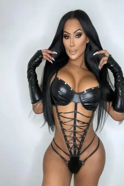 Sexy trans woman posing in a skimpy leather outfit
