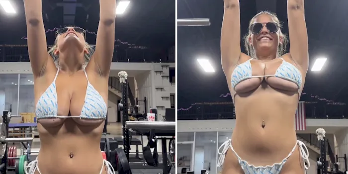 Big tit girl attempting a pull-up in a bikini