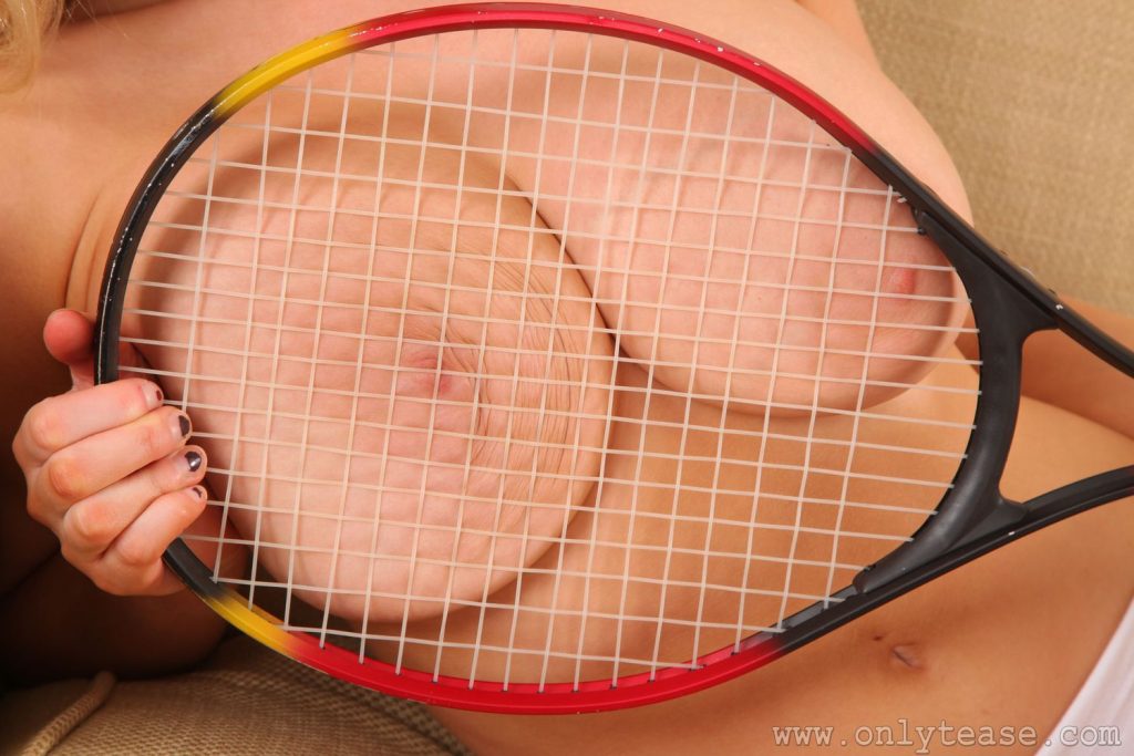 Close up of the big boobs squeezed by a Tennis racket
