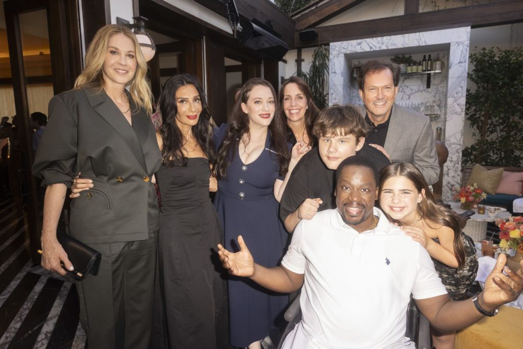 Kat Dennings in the middle of a big group of people at a party