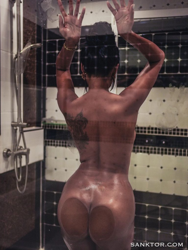 Nude Asian model pushing her ass against the shower glass
