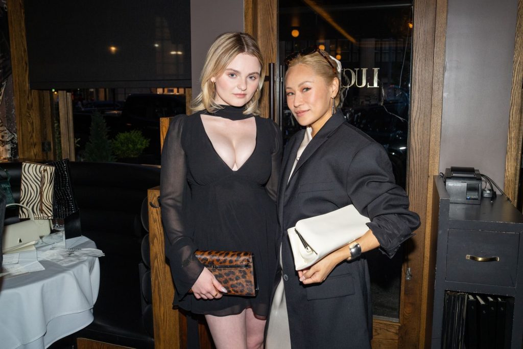 Morgan Lily posing next to a pretty Asian girl at a party