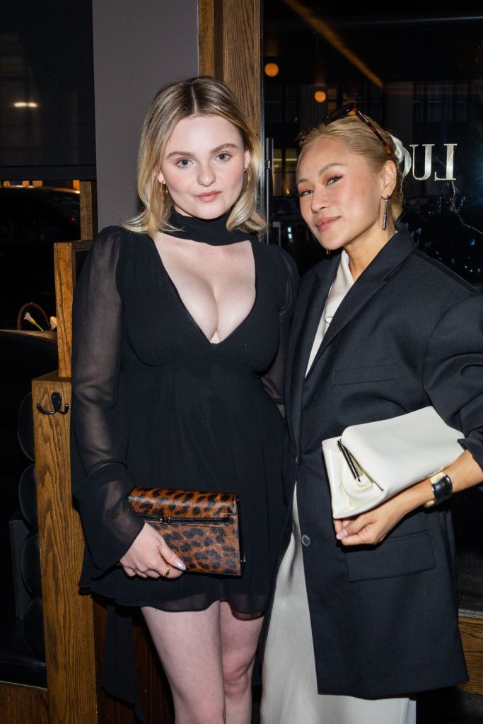 Closer view of Morgan Lily posing next to a pretty Asian girl at a party