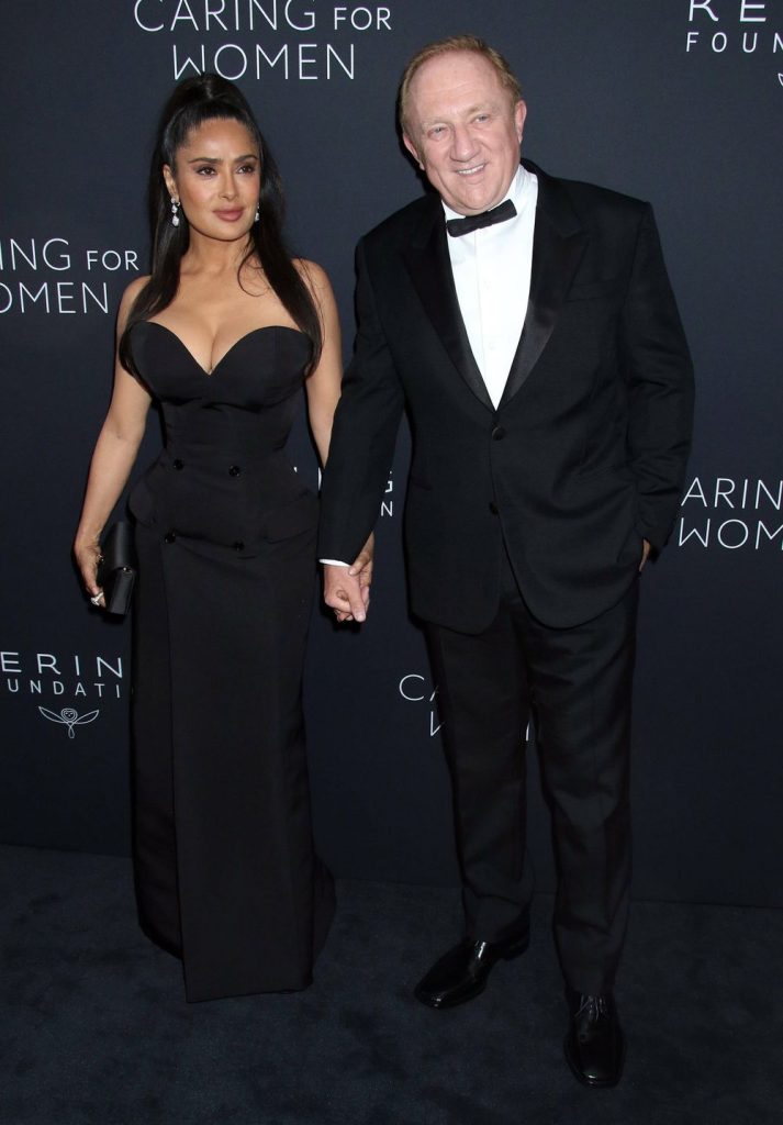 Salma Hayek holding hands with her husband on the red carpet