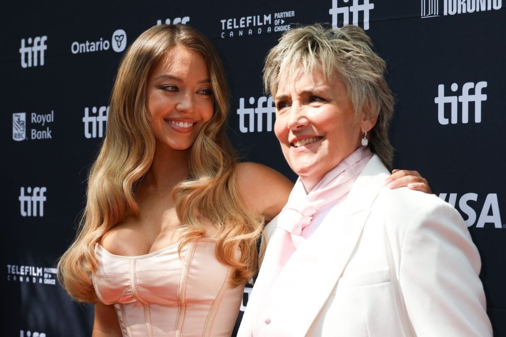 Sydney Sweeney looks and smiles at Christy Martin