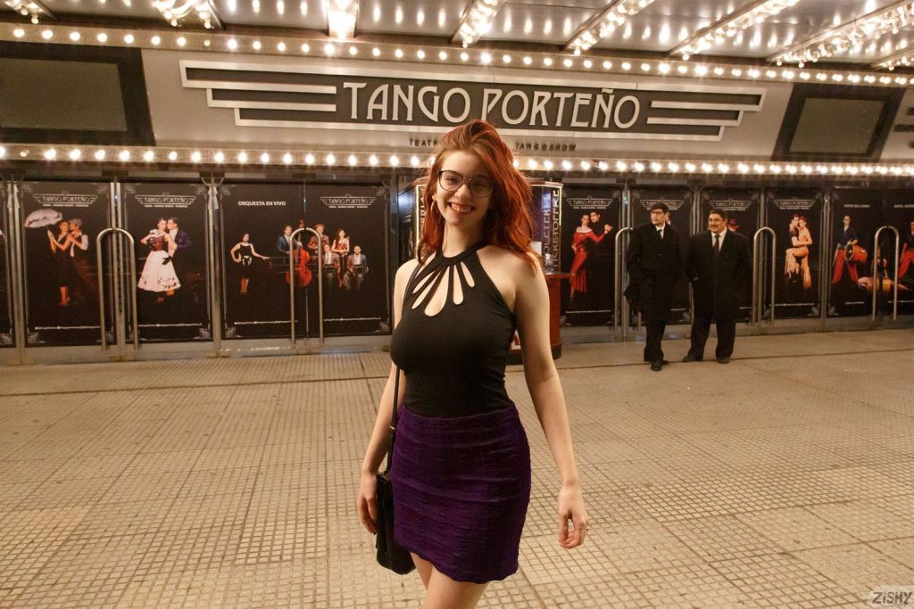 Redhead wearing a nice dress in front of Tango Porteno