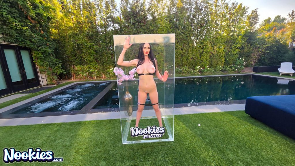 Far view of nude sexbot Violet Voss inside a glass box which is sitting on the grass
