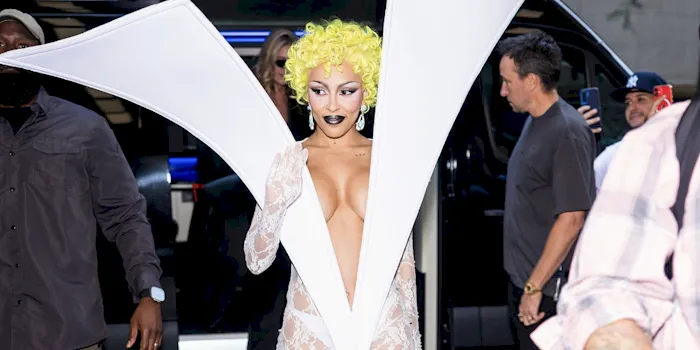Doja Cat with yellow hair and a strange dress