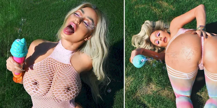 Aubrey O'Day showing big tits in the grass while wearing see through lingerie
