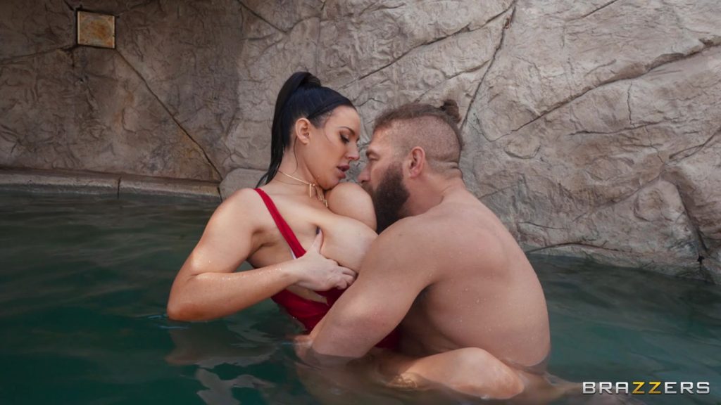 Man sucking on one of Angela White's big boobs in a pool