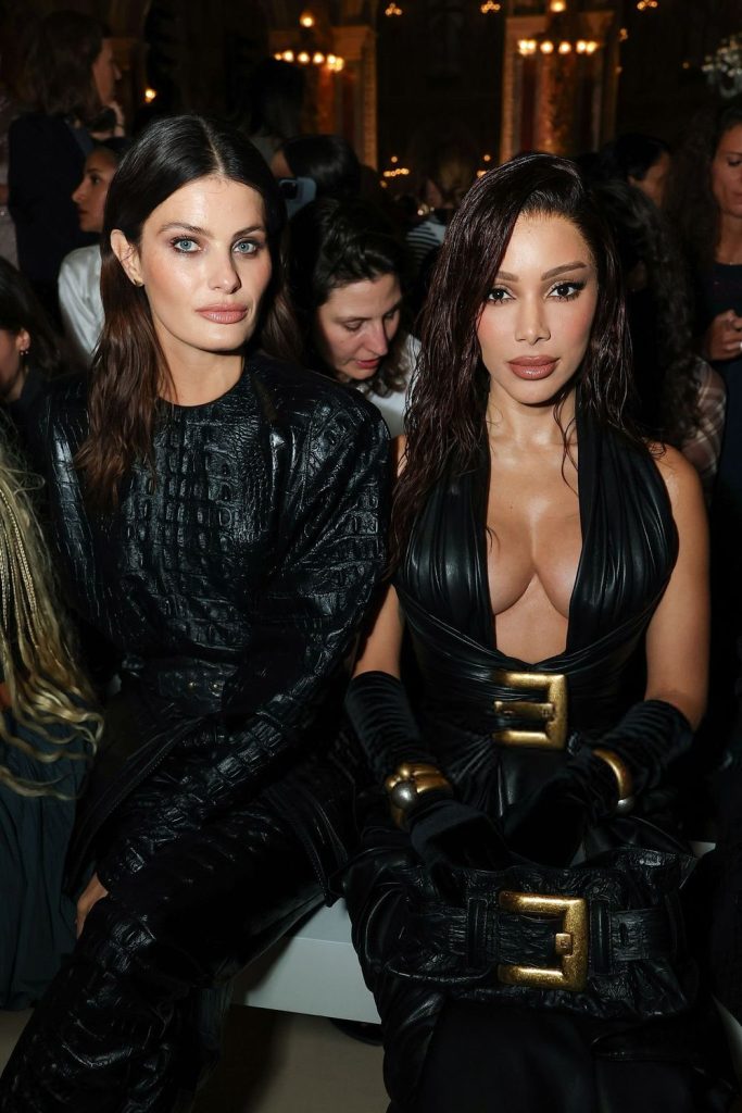 Closer view of Anitta and her cleavage sitting in the audience of a fashion show