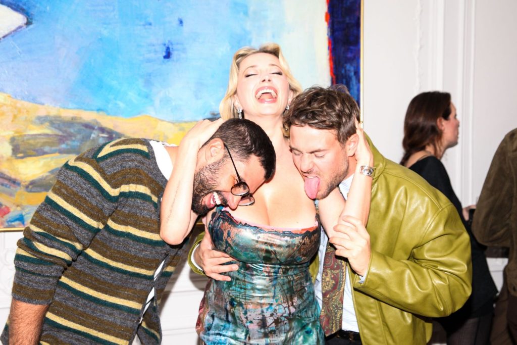 Slightly different view of guys pretending to lick Caroline Vreeland's boobs
