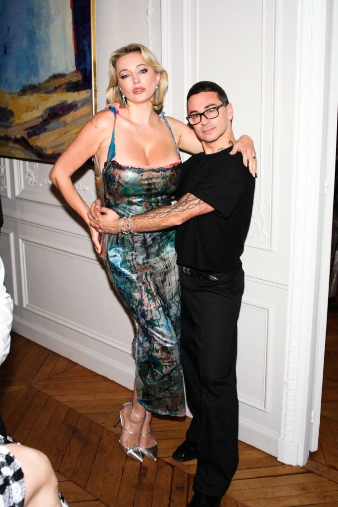 Short man putting his hands around Caroline Vreeland