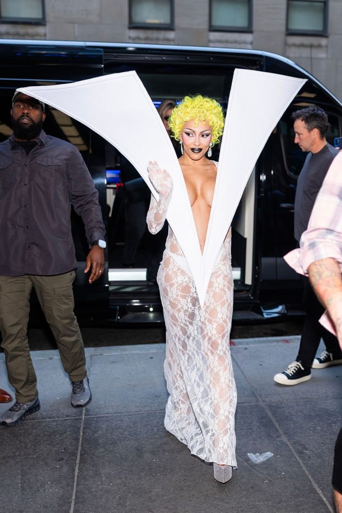 Further shot of Doja Cat walking and waving to her fans