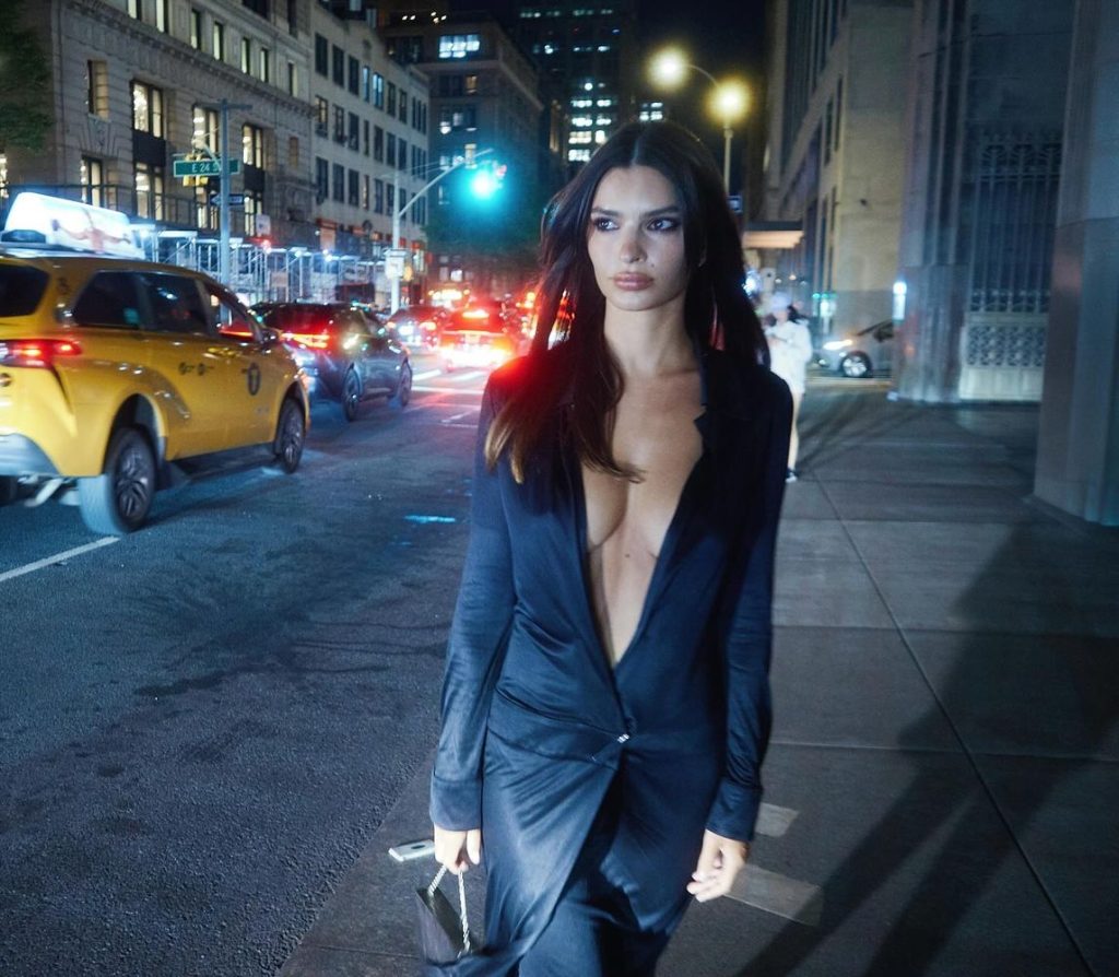 Close up view of Emily Ratajkowski showing cleavage on a public sidewalk