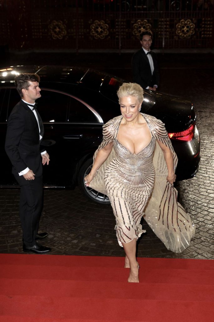 Hannah Waddingham down blouse cleavage as she exits a car and begins to walk up a red carpet staircase