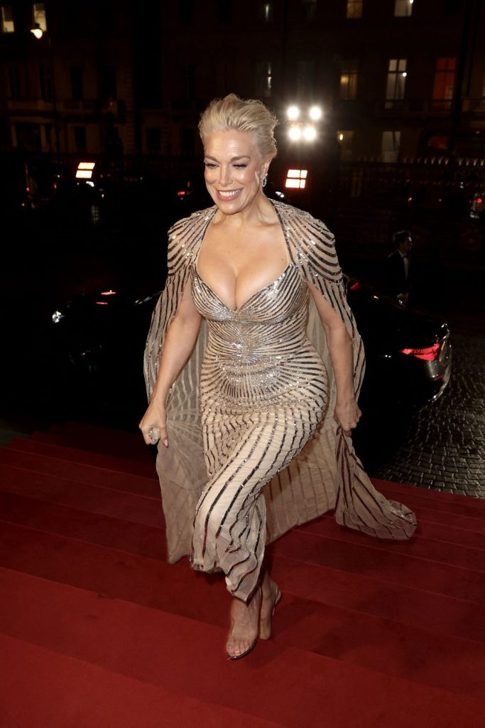 Closer view of Hannah Waddingham showing down blouse on a staircase
