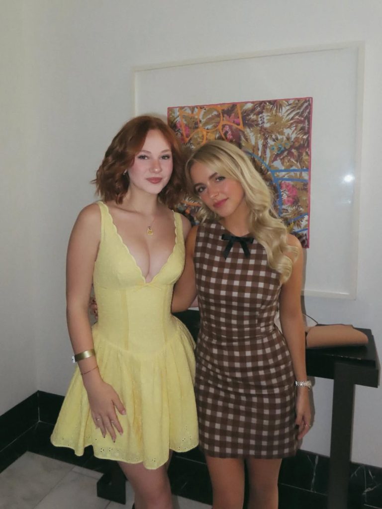 Lily Brooks O'Briant posing next to a blonde girl wearing the same yellow dress