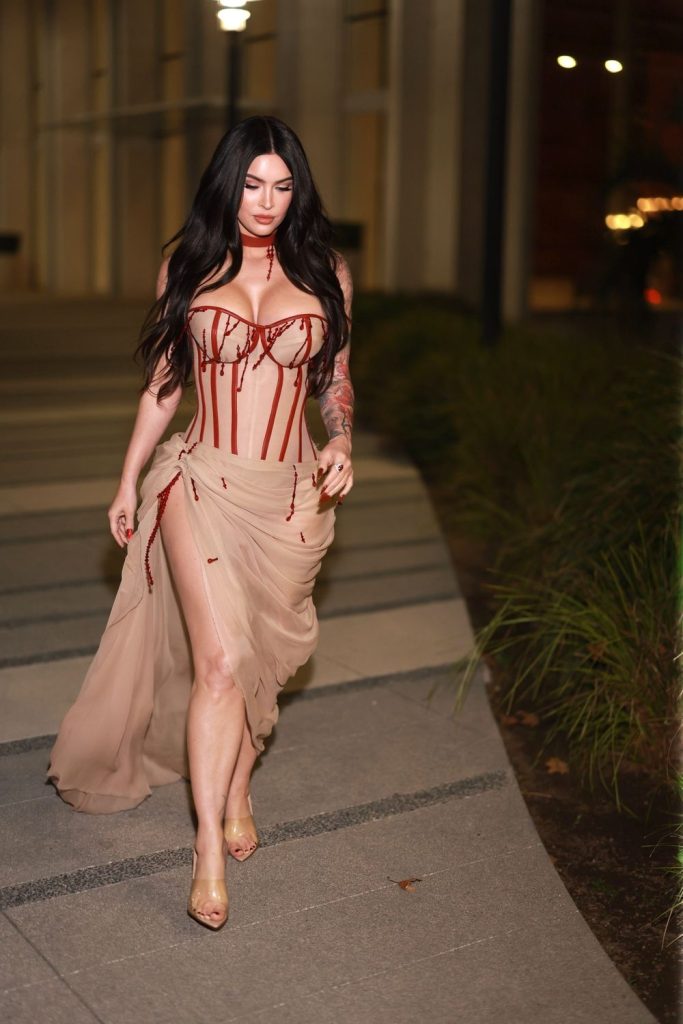 Megan Fox looking down while walking