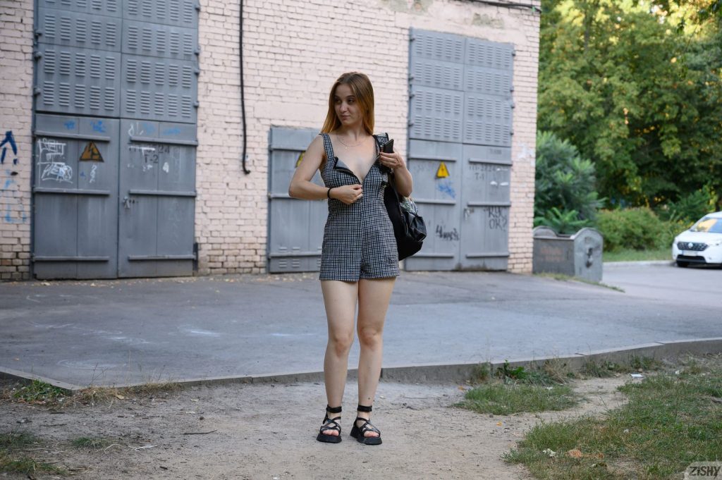 Pretty blonde out in a park wearing a nice jumpsuit