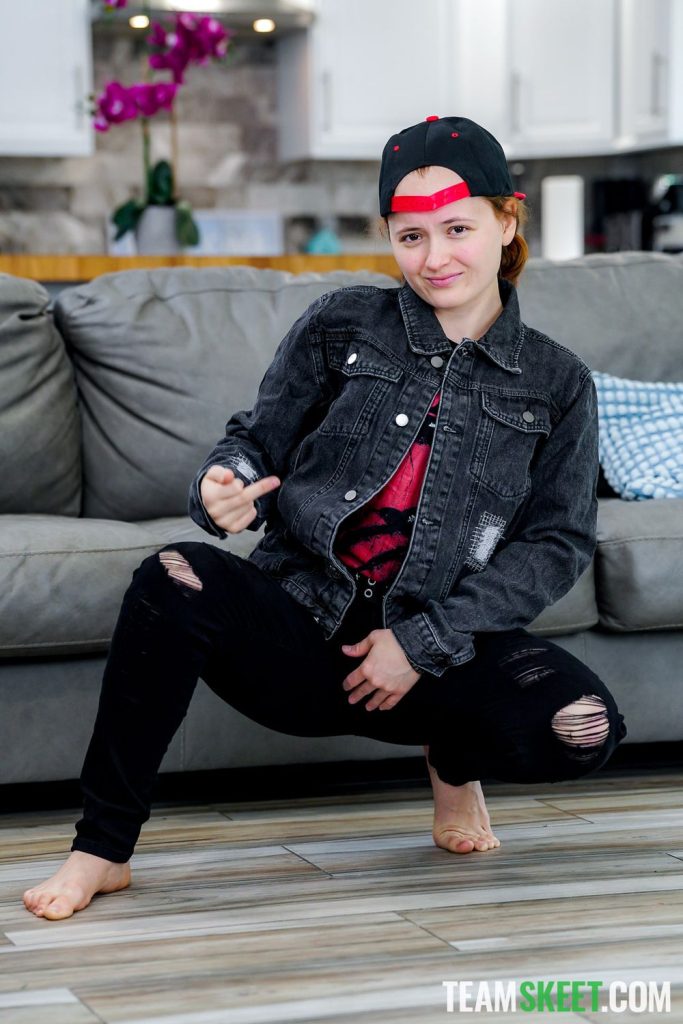 Frontal view of tomboy squatting down and flipping the bird