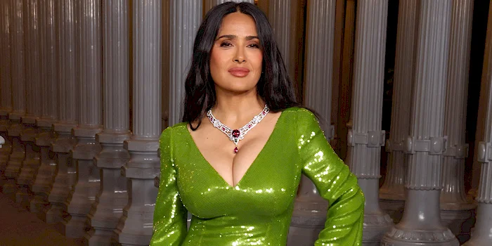 Cropped version of Salma Hayek's breasts in a green dress