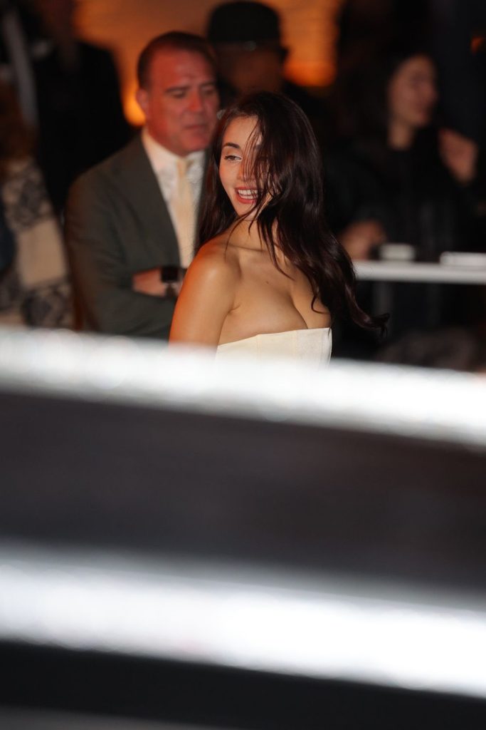 Candid photo of Caylee Cowan's face and chest as she walks towards a car