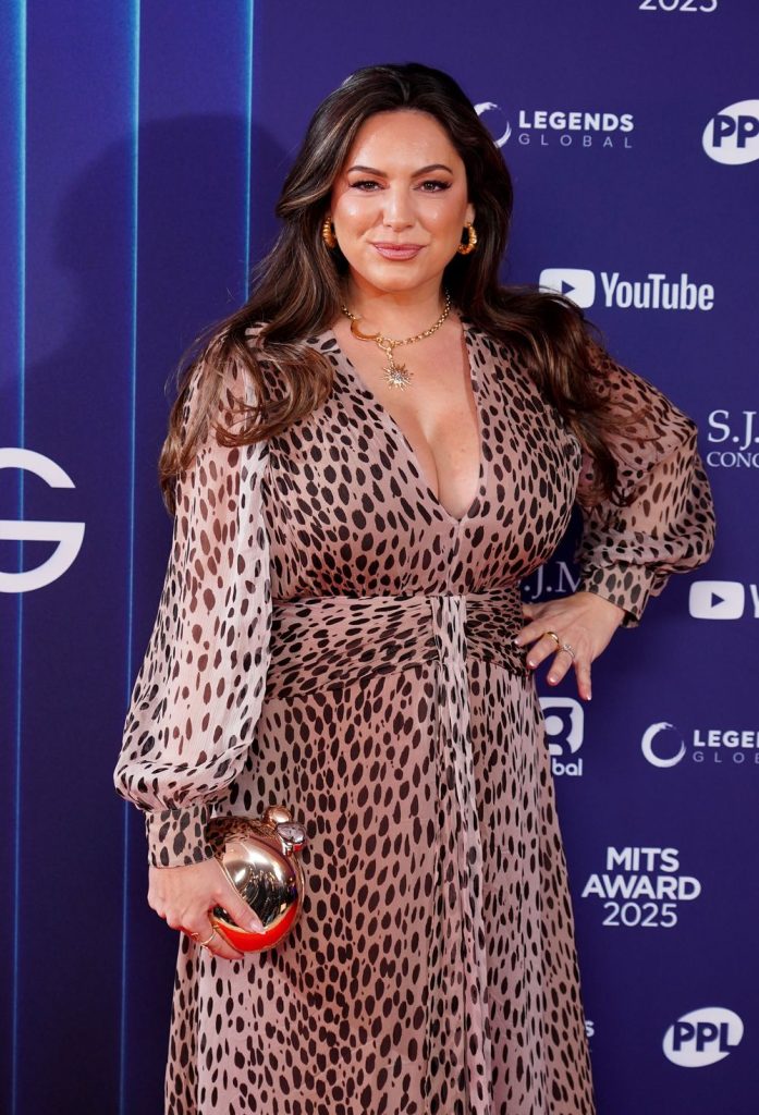 Close up of Kelly Brook with a hand on her hip