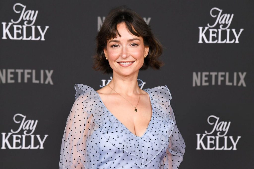 Wide close up of Milana Vayntrub with a big smile on her face