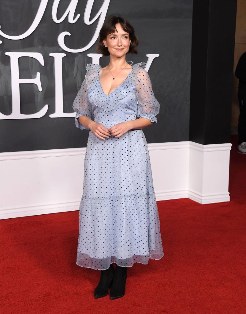 Full body view of Milana Vayntrub standing at an angle on the red carpet