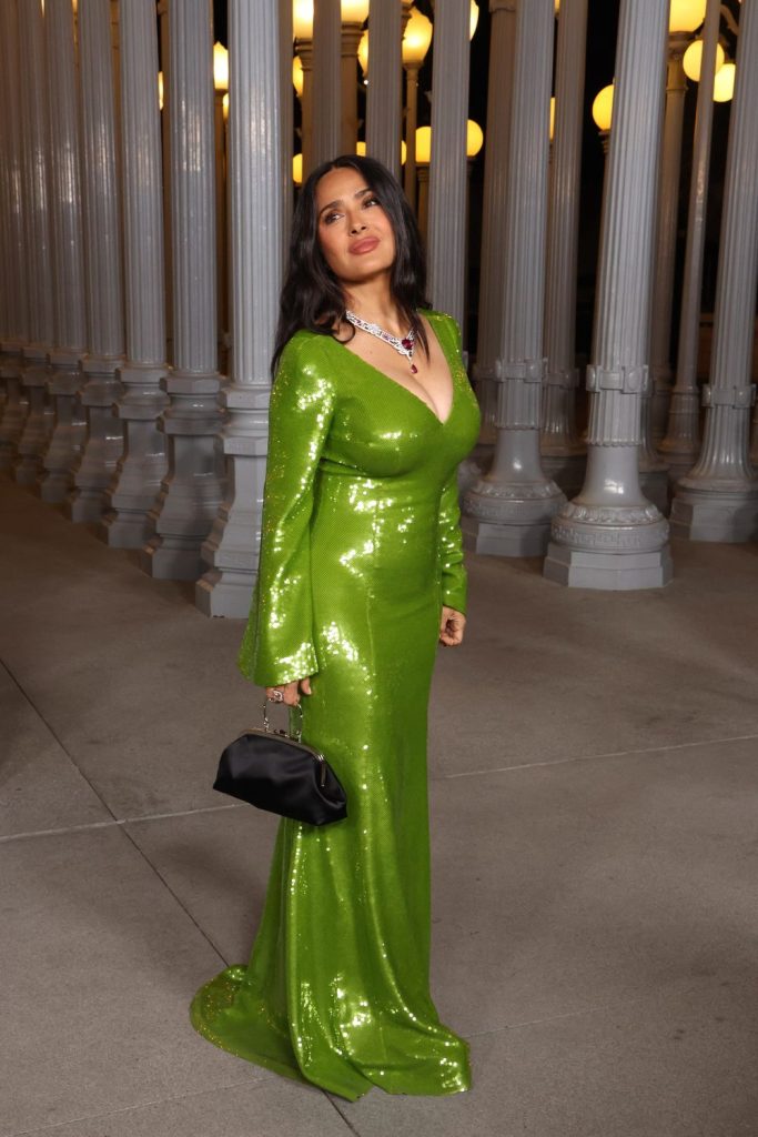 Full body view of Salma Hayek turned to the side in front of many street lights