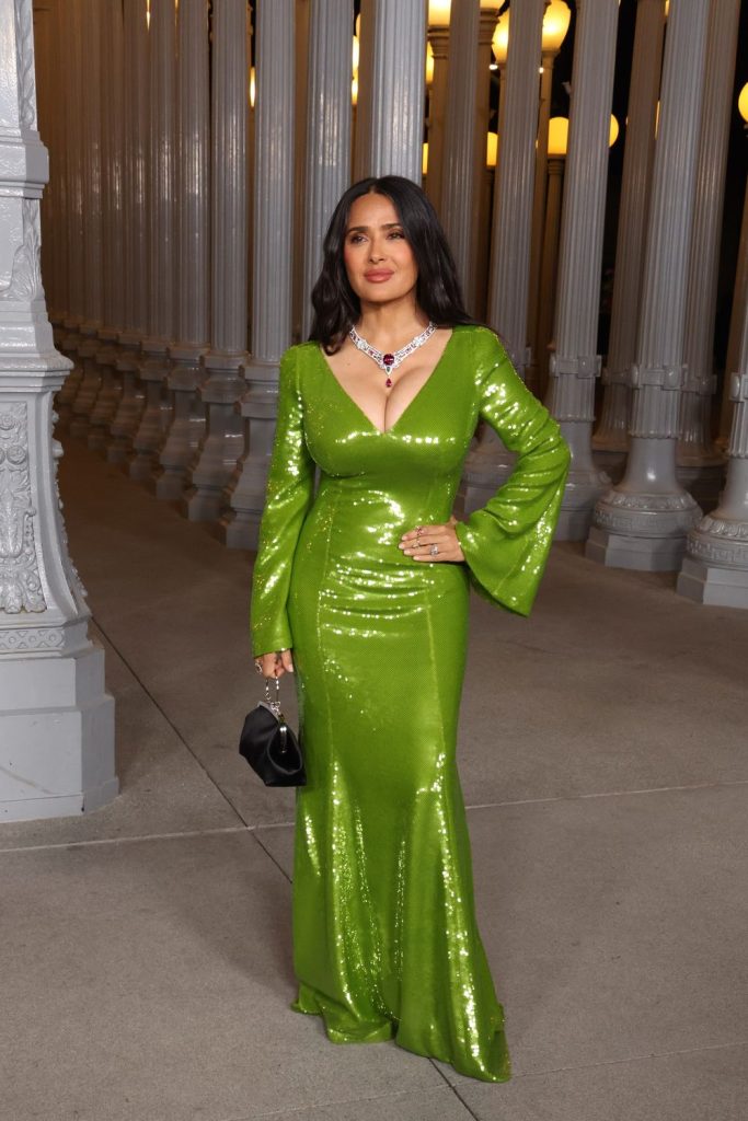 Full body frontal view of Salma Hayek posing with a hand on her hip