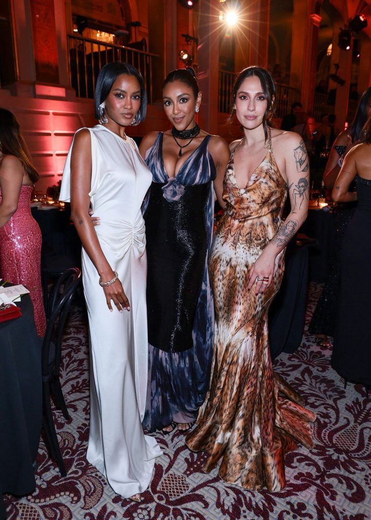 Three women including Tayshia Adams posing together at a party