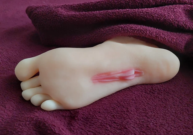 The bottom of a rubber foot with a vagina in the sole
