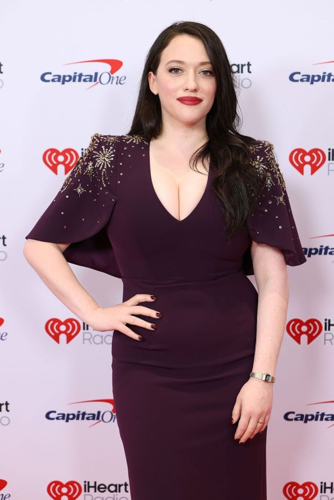 Closer view of Kat Dennings posing with one hand on her hip