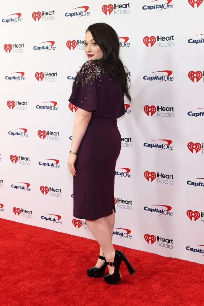 Backside full body view of Kat Dennings on the red carpet