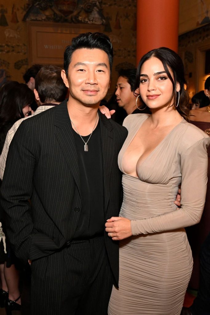 Frontal of woman and man posing close to each other at an event