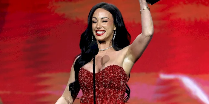Cropped close up of woman celebrating an award win on stage