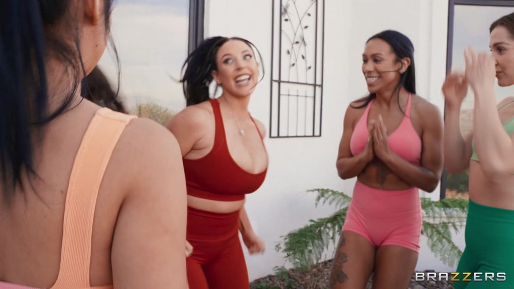 A group of women wearing workout gear standing in a circle