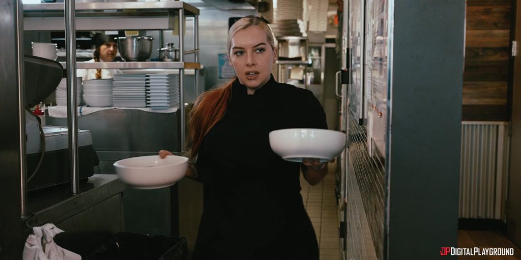 Frontal of female chef carrying two big bowls
