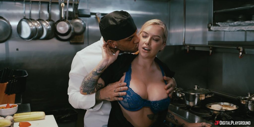 Male sous chef standing behind female chef undressing her