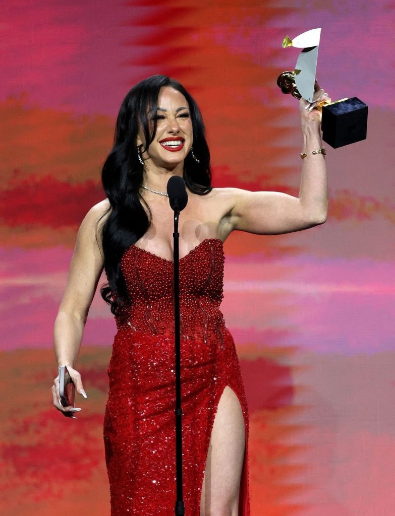 Jennifer White accepting her award on stage at the AVN Awards