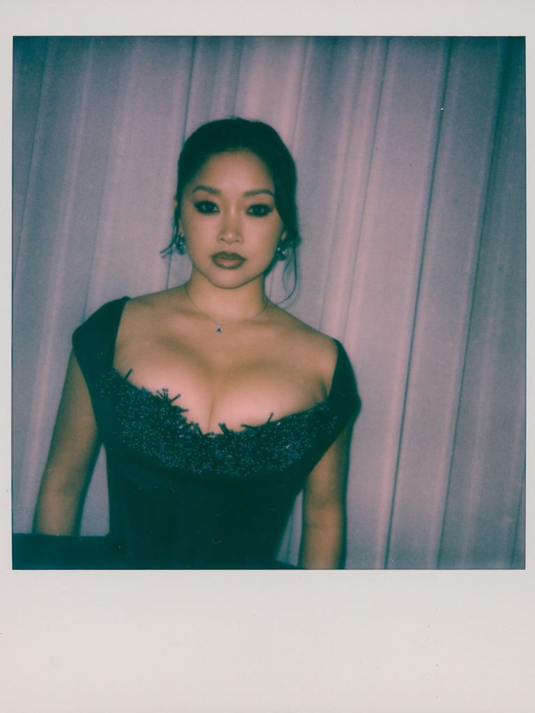 Polaroid picture of Asian woman's face and chest wearing a fancy dress