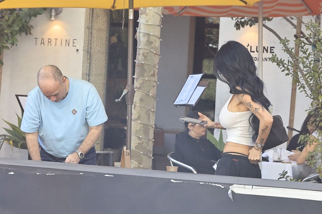 Looking through a window of a man and woman getting up inside a restaurant