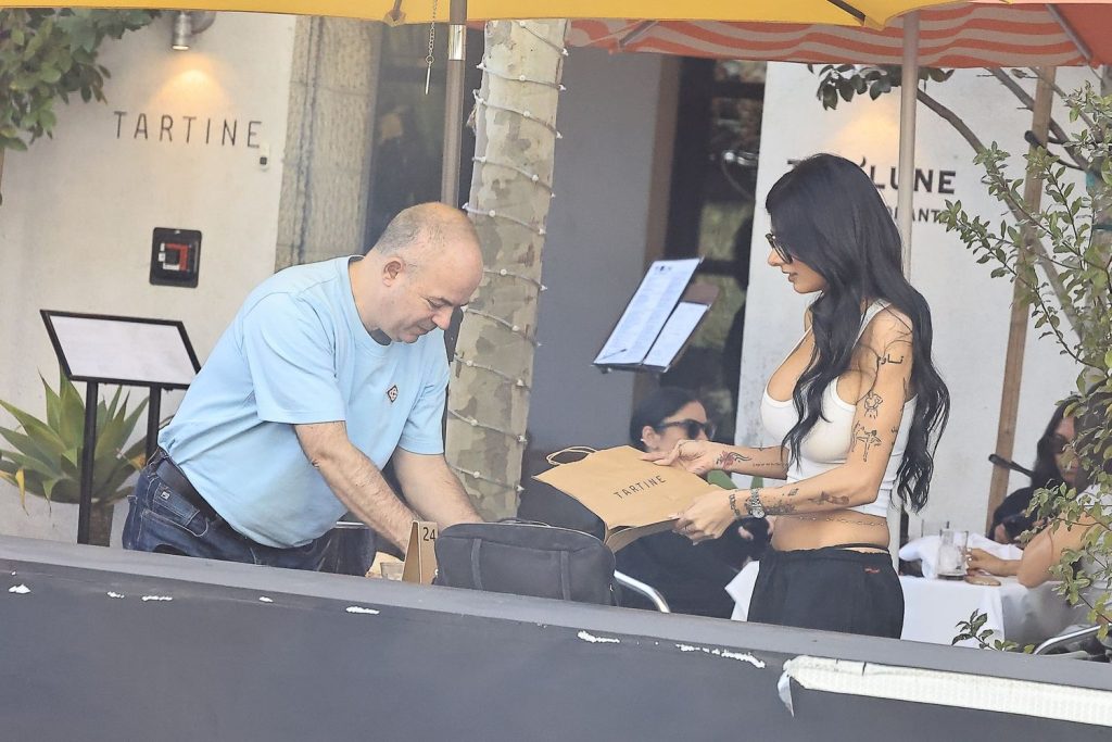 Side view looking through a window of man and woman preparing to leave a restaurant