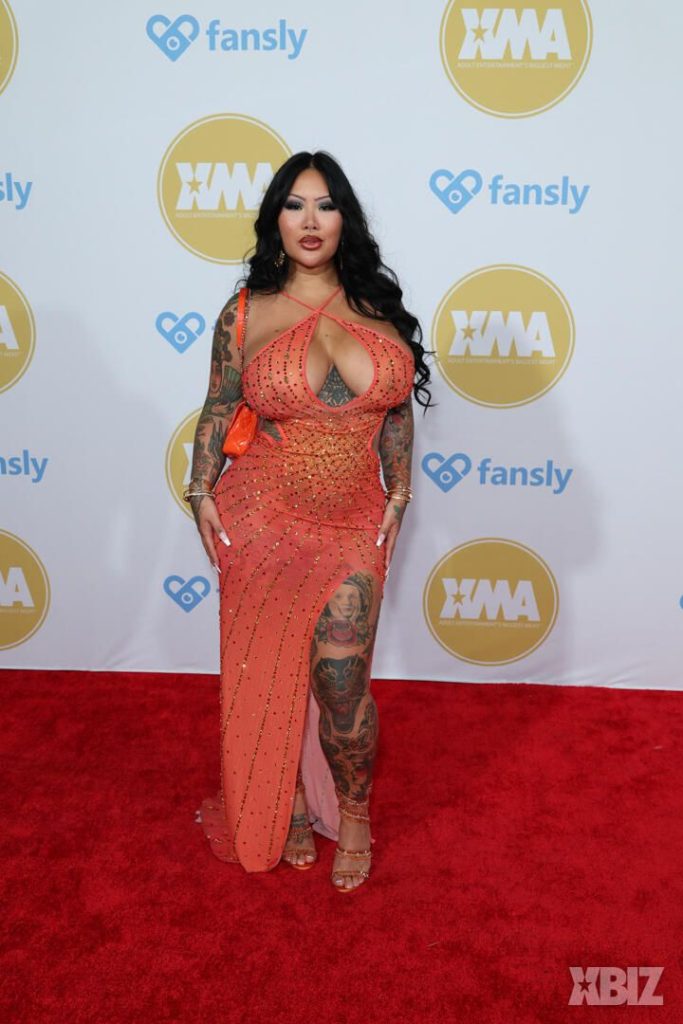 Frontal of Asian porn star in sexy dress on the red carpet