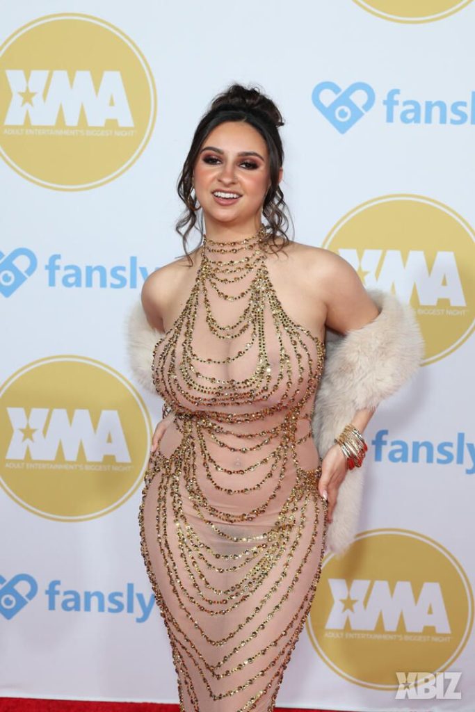 Closer frontal of porn star in sexy dress on the red carpet