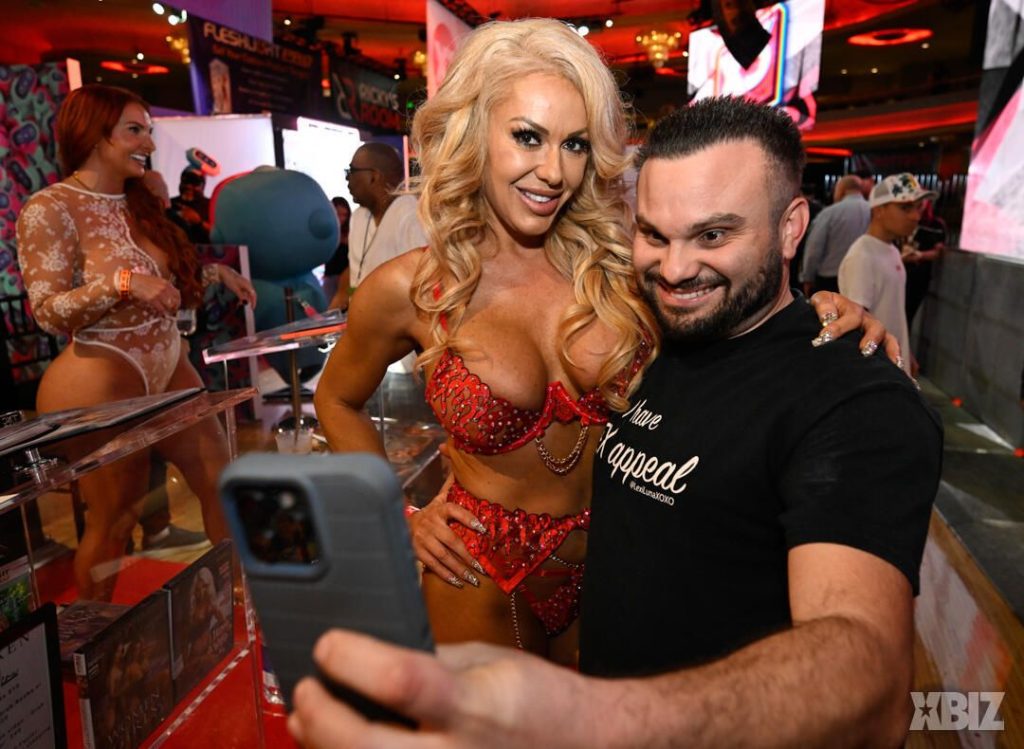 Porn star and fan smiling while taking a selfie