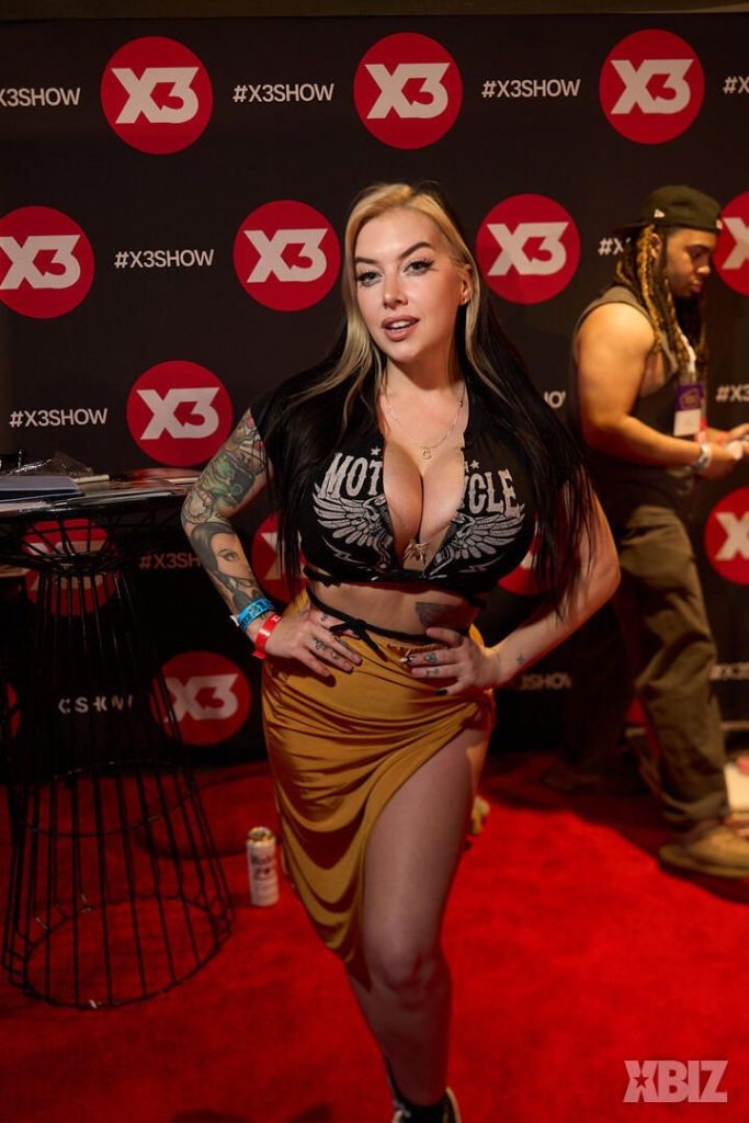 Frontal of porn star posing with hands on hips at a convention