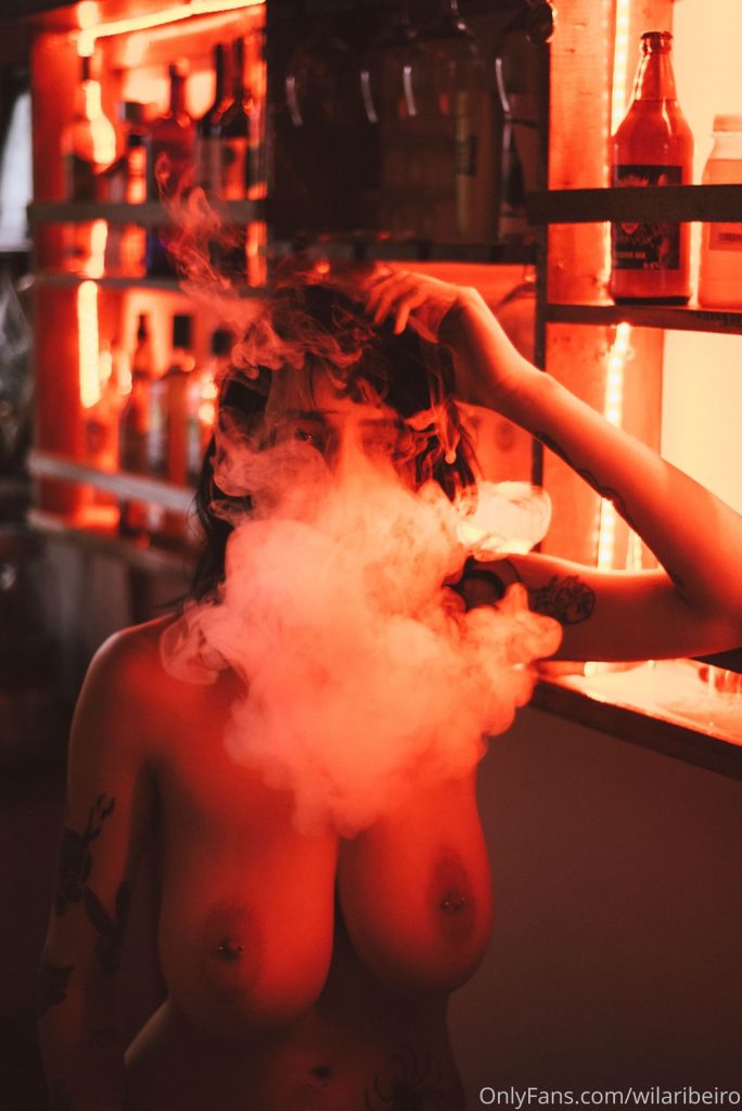 Big puff of smoke in front of topless woman